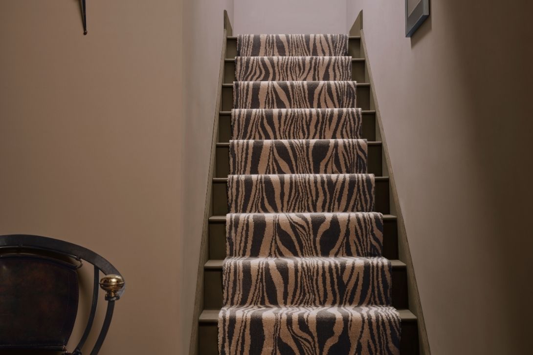 a staircase with zebra carpet
