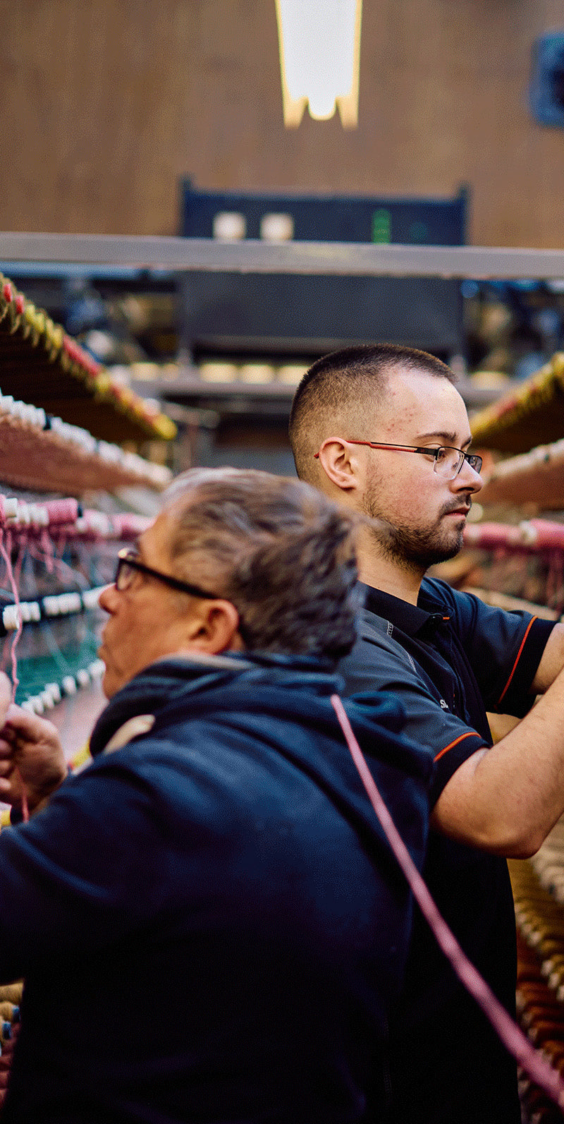 a man and woman working in a factory