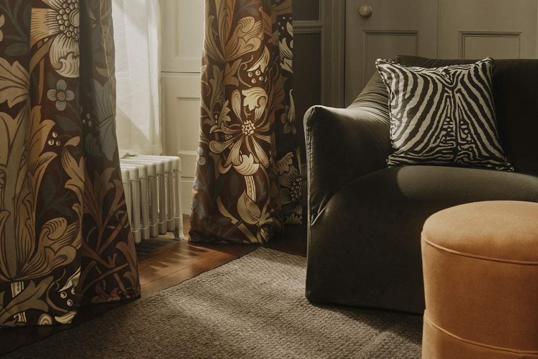 a couch with pillows in front of a door