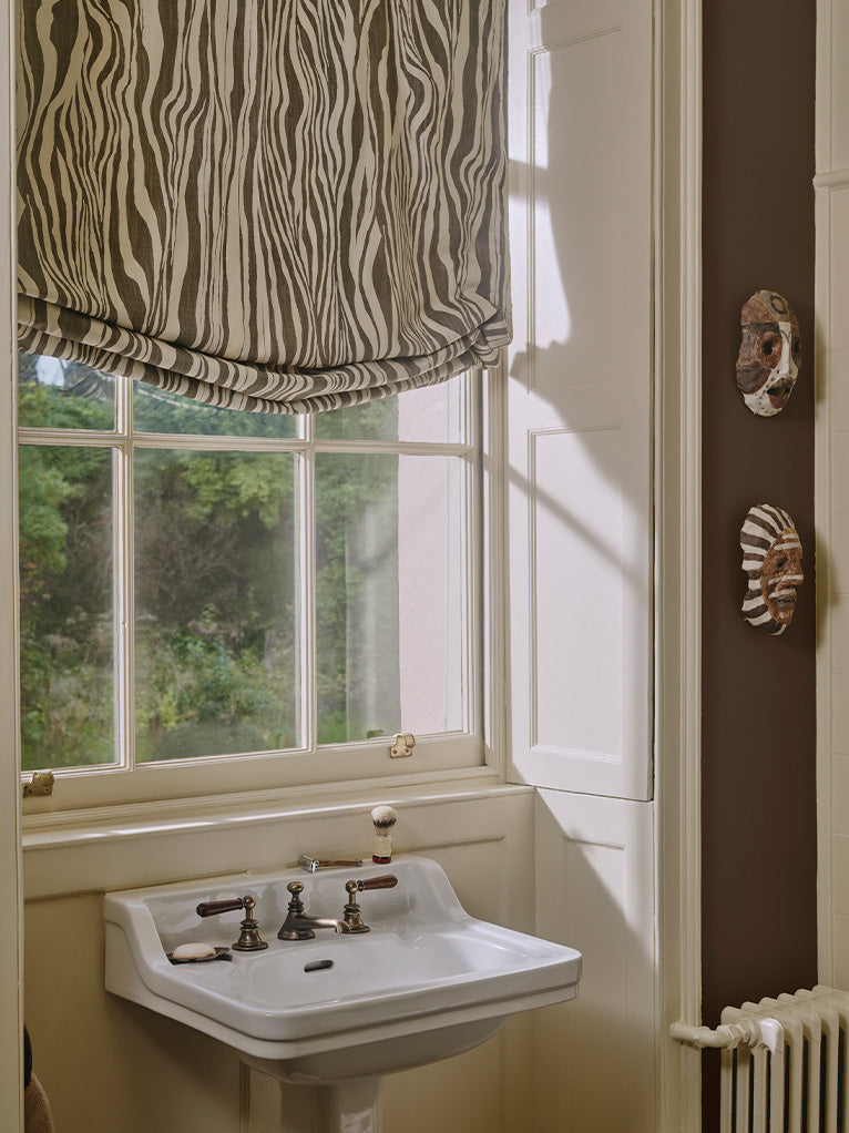 a bathroom with a window and a sink