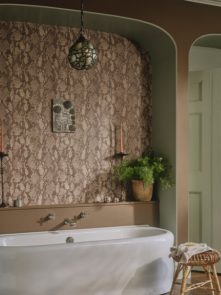 a bathroom with a bathtub and a plant