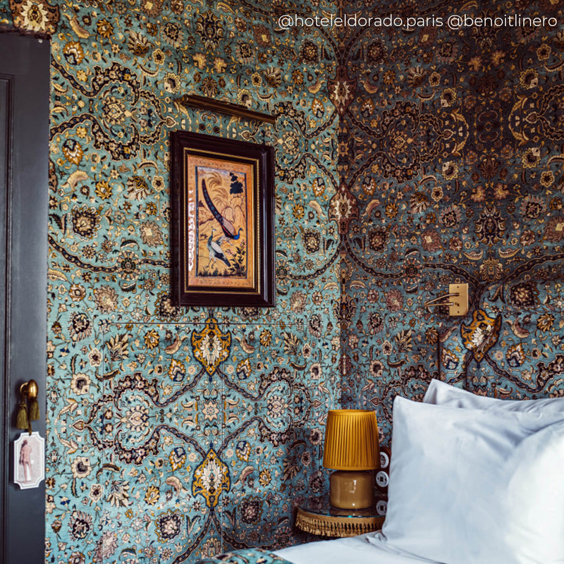 a bed with pillows and a lamp on a table