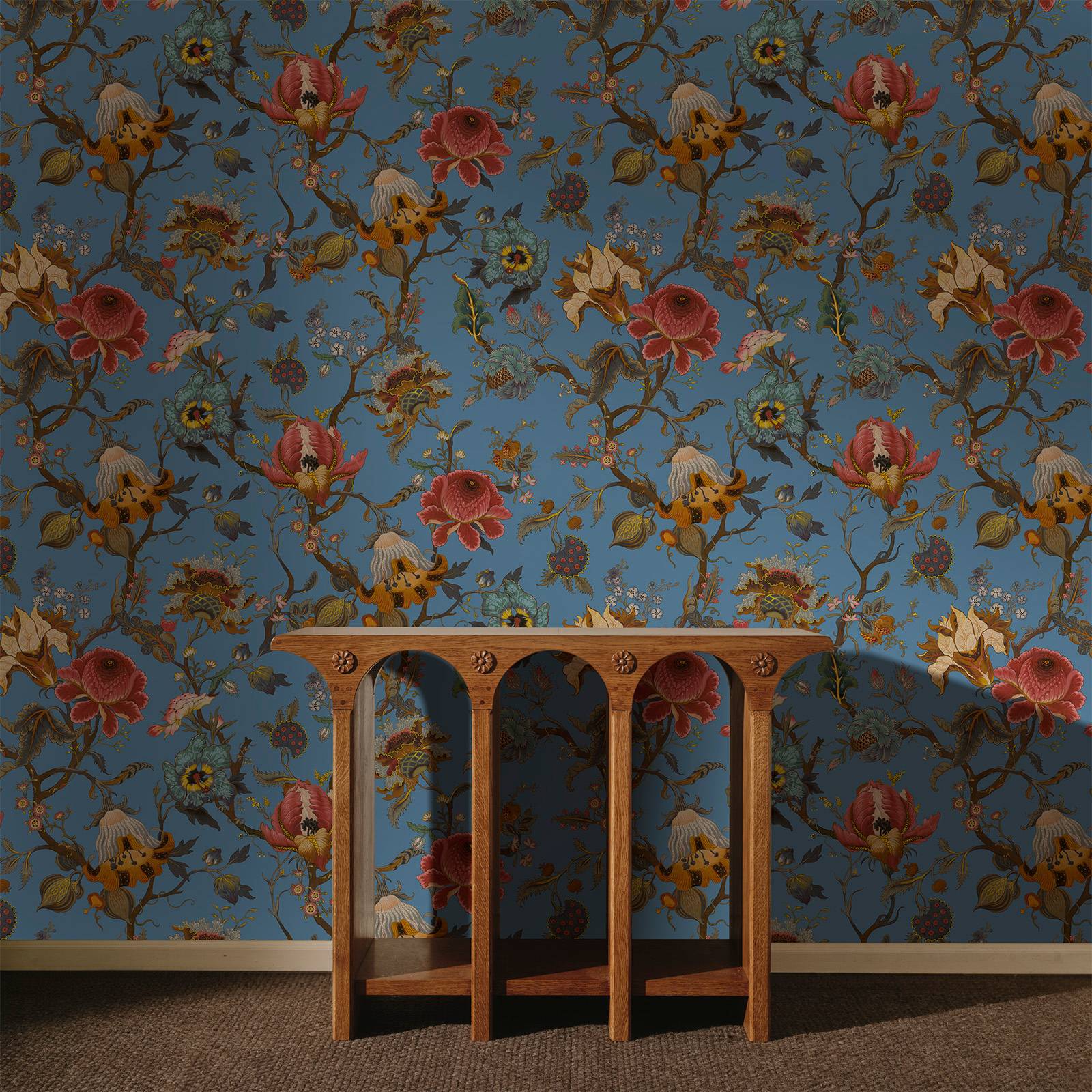 a wooden shelf in front of a wall with floral wallpaper