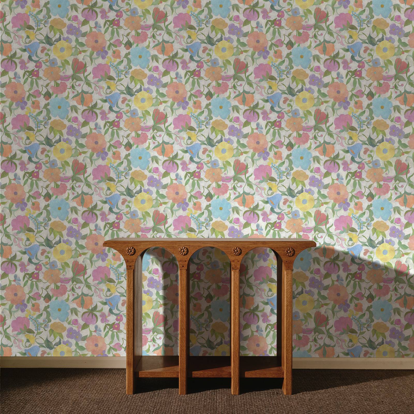 a wooden table in front of a wall with flowers