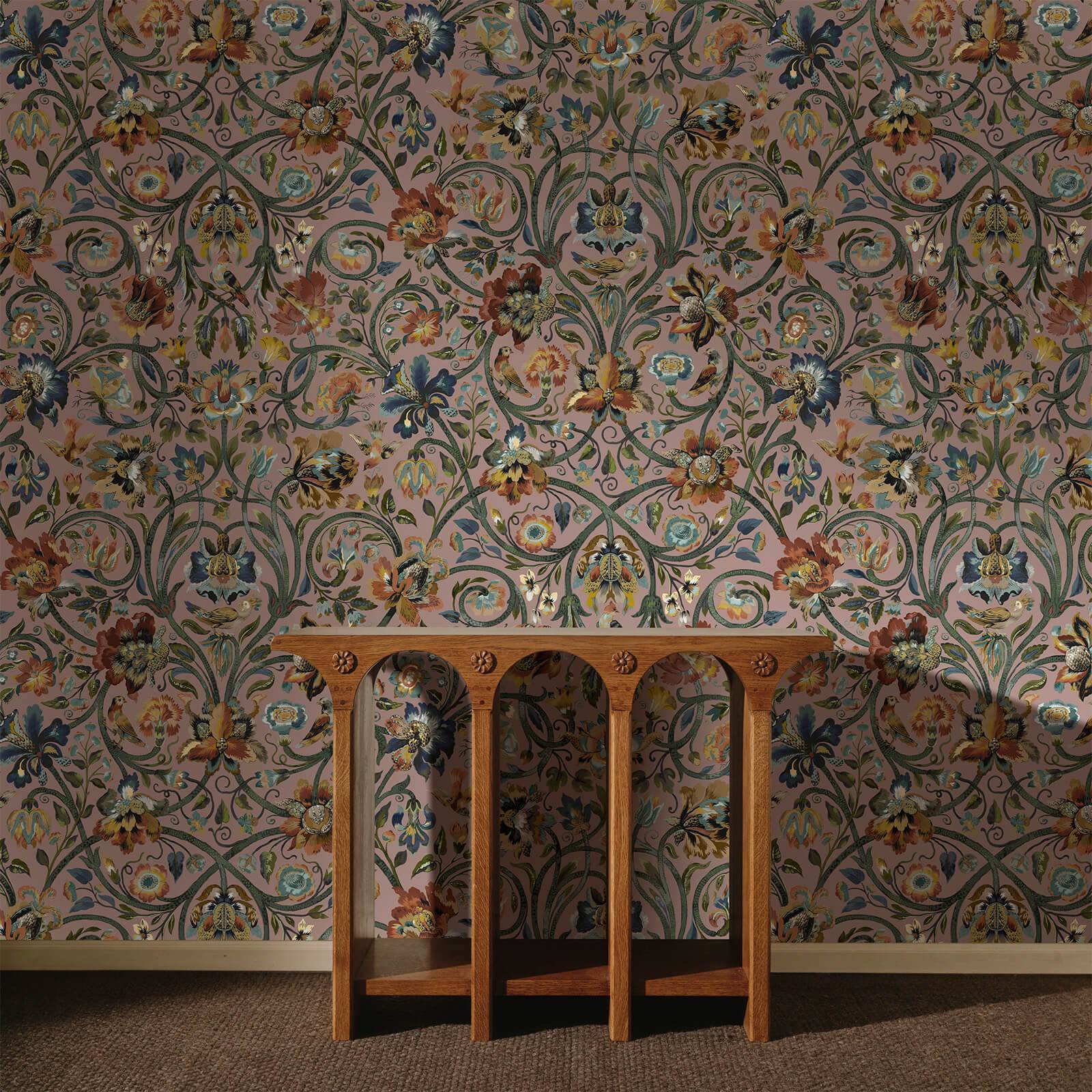 a wooden table in front of a floral wallpaper