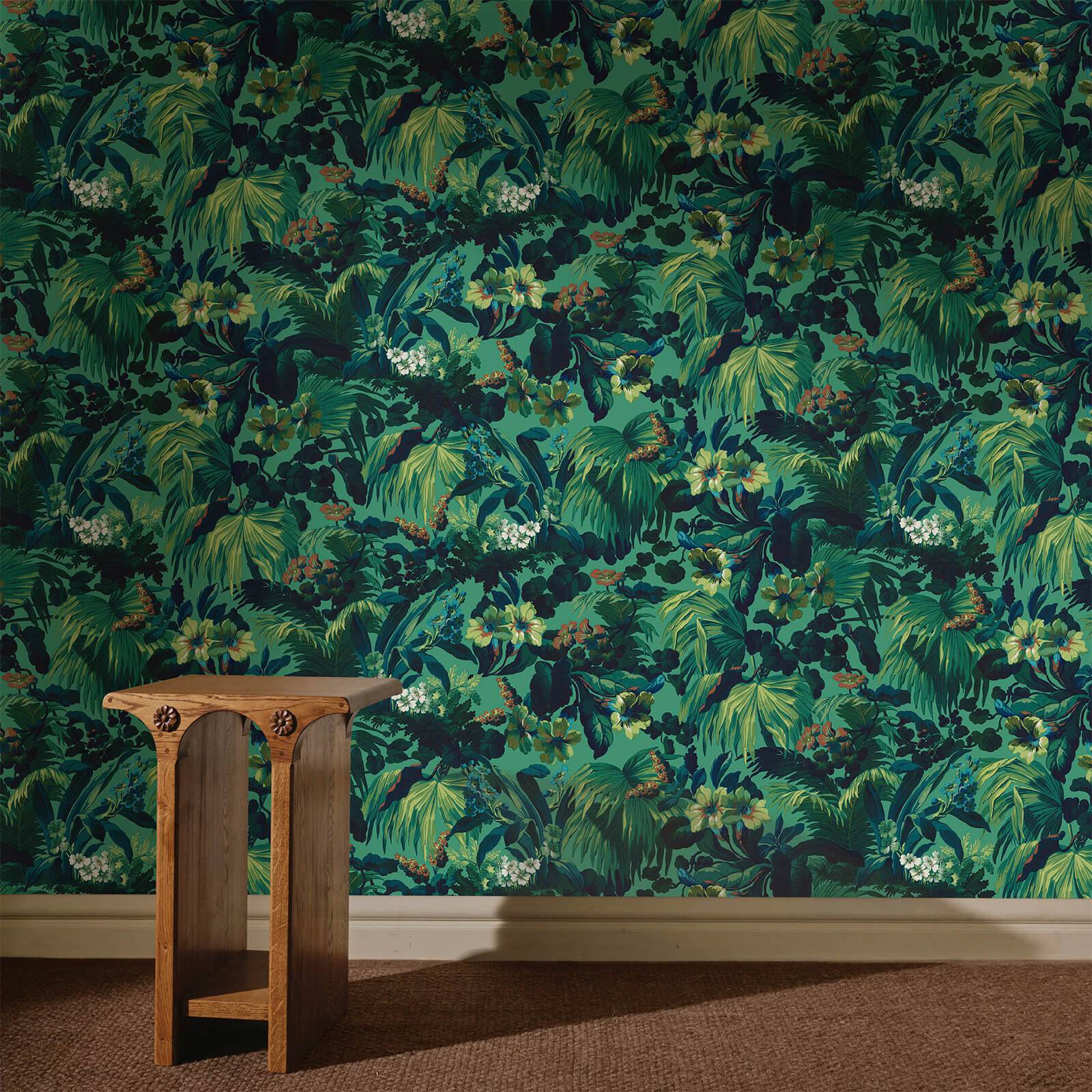 a wooden table in front of a wall with a floral wallpaper