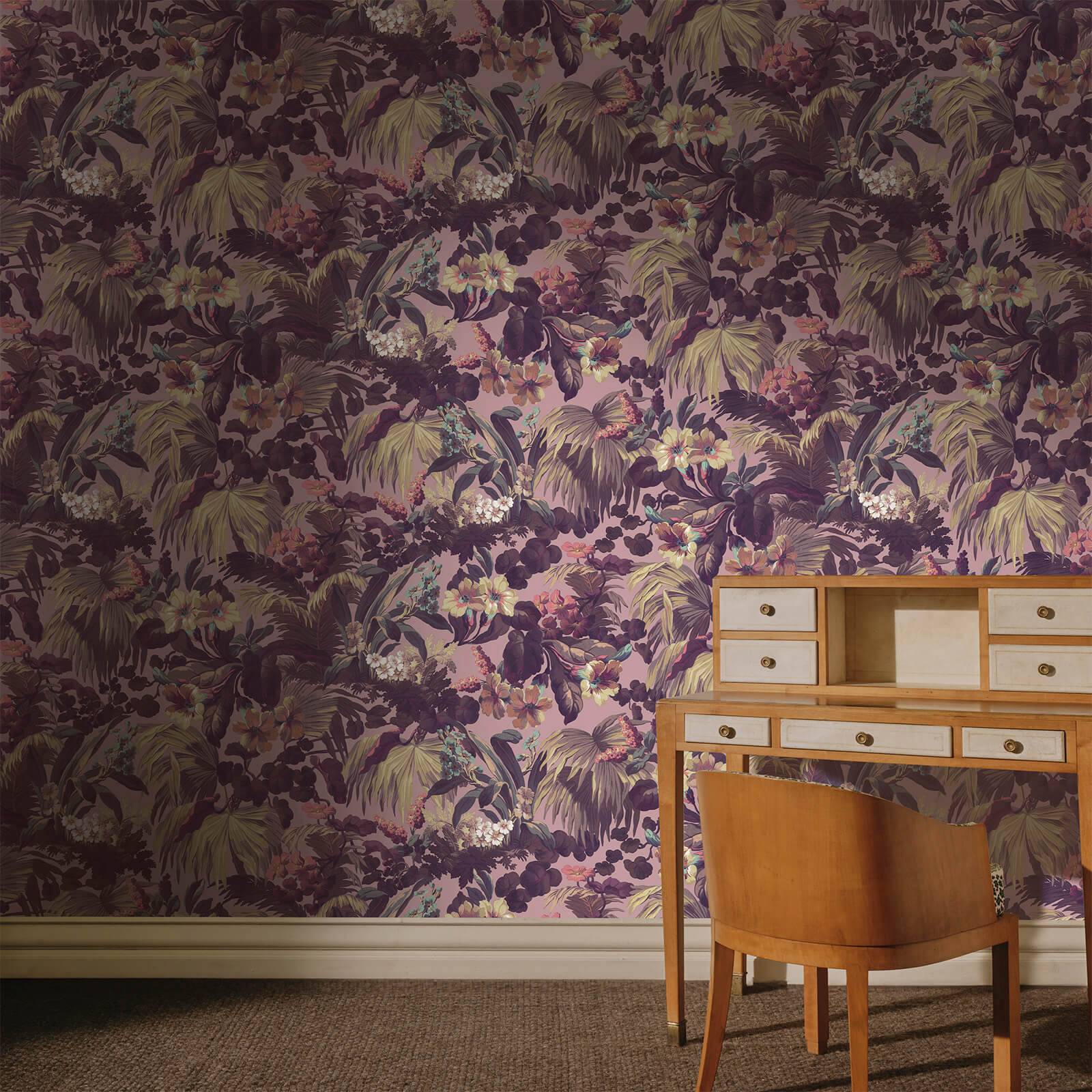 a desk and chair in a room with floral wallpaper