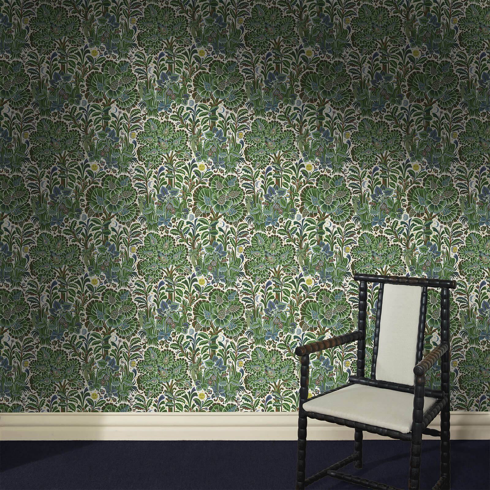 a chair in a room with a floral wallpaper