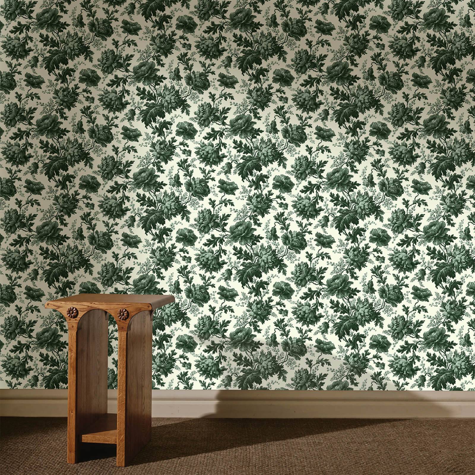 a wooden table in a room with a floral wallpaper