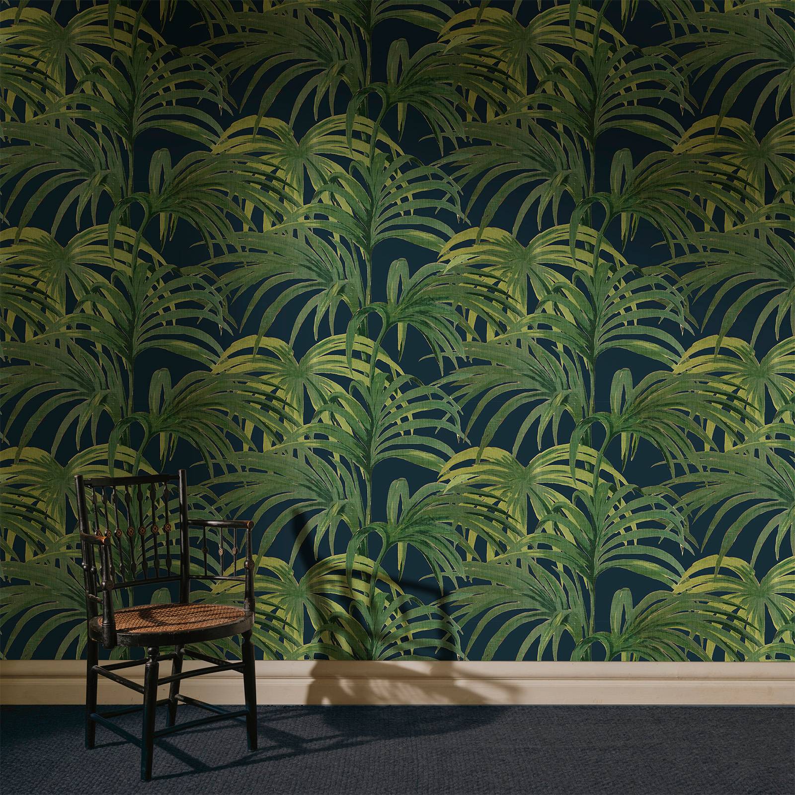 a chair in front of a wall with a pattern of palm trees