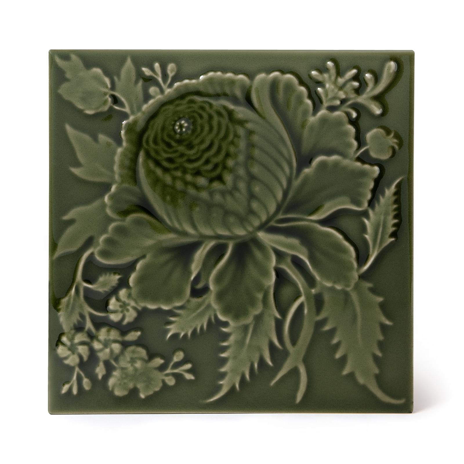a green tile with a flower design