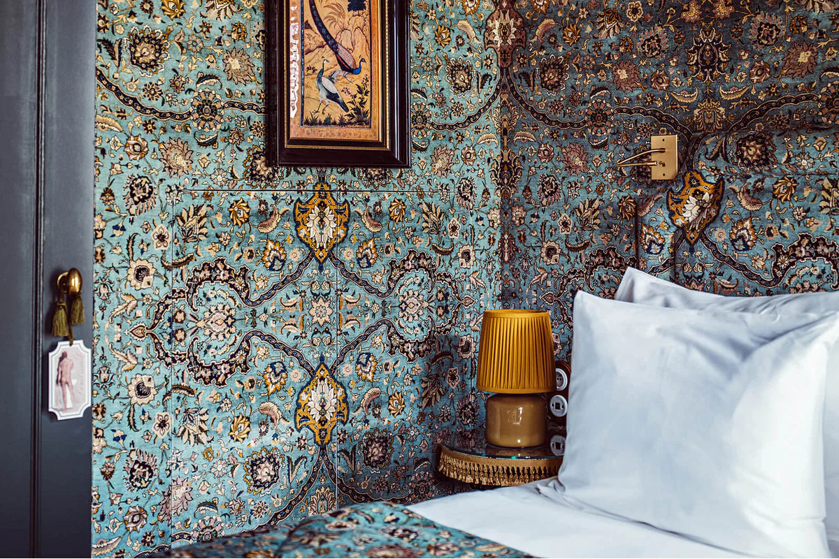 a bed with a lamp on the side